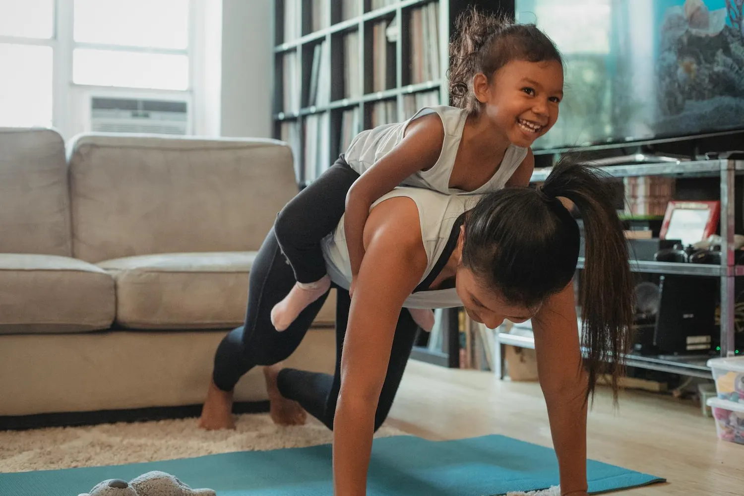 A mother and daughter working out together at home